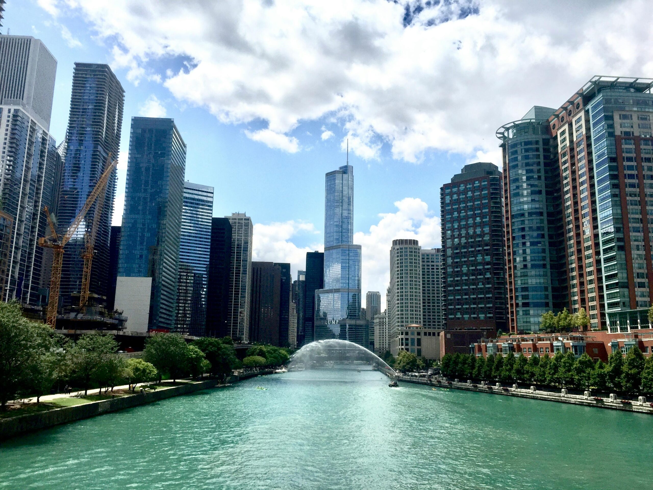 A stunning view of Chicago's skyline and river, featuring iconic skyscrapers under a bright blue sky.