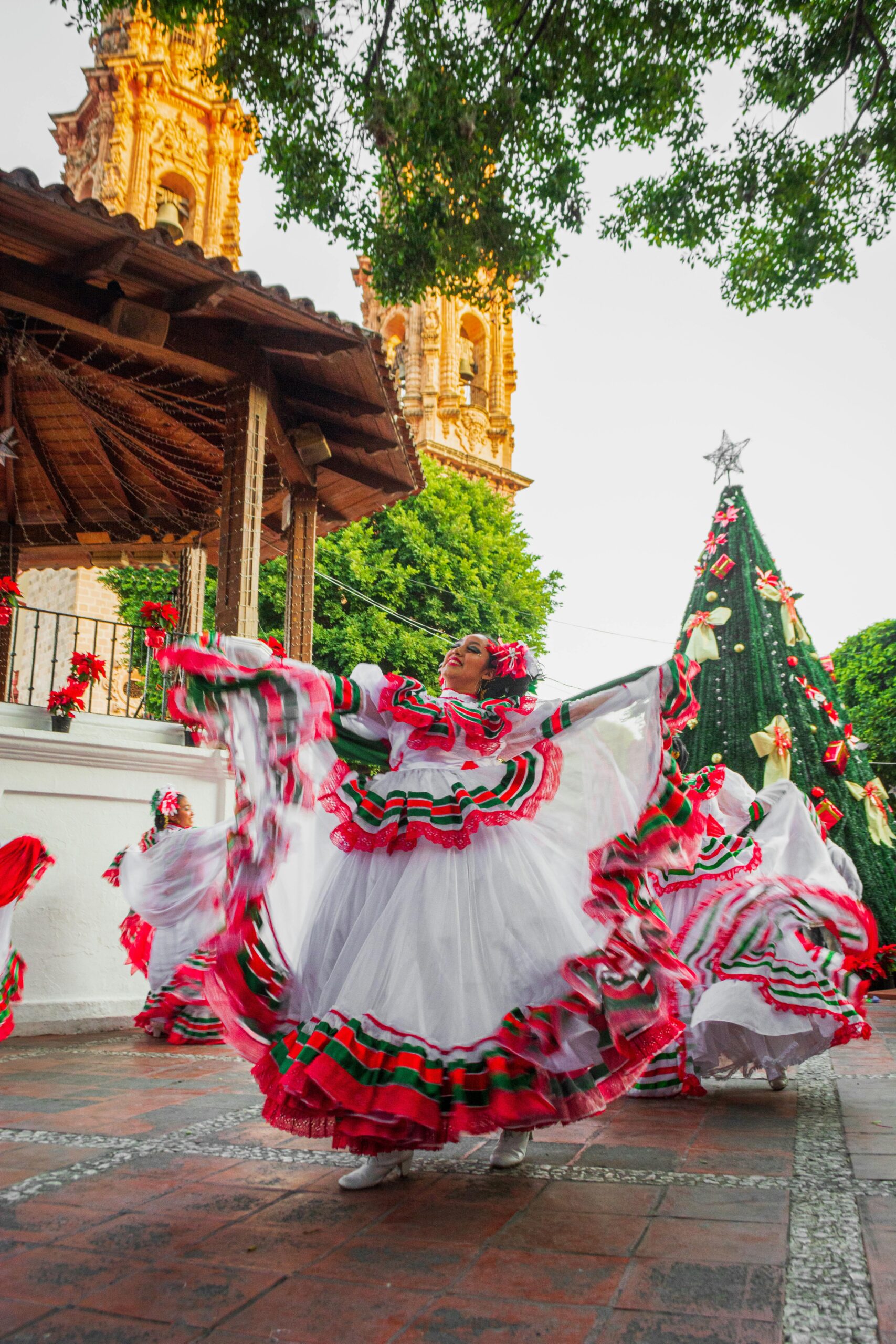 Vibrant celebration of Mexican culture with dancers in traditional attire during a Christmas festival in Taxco.